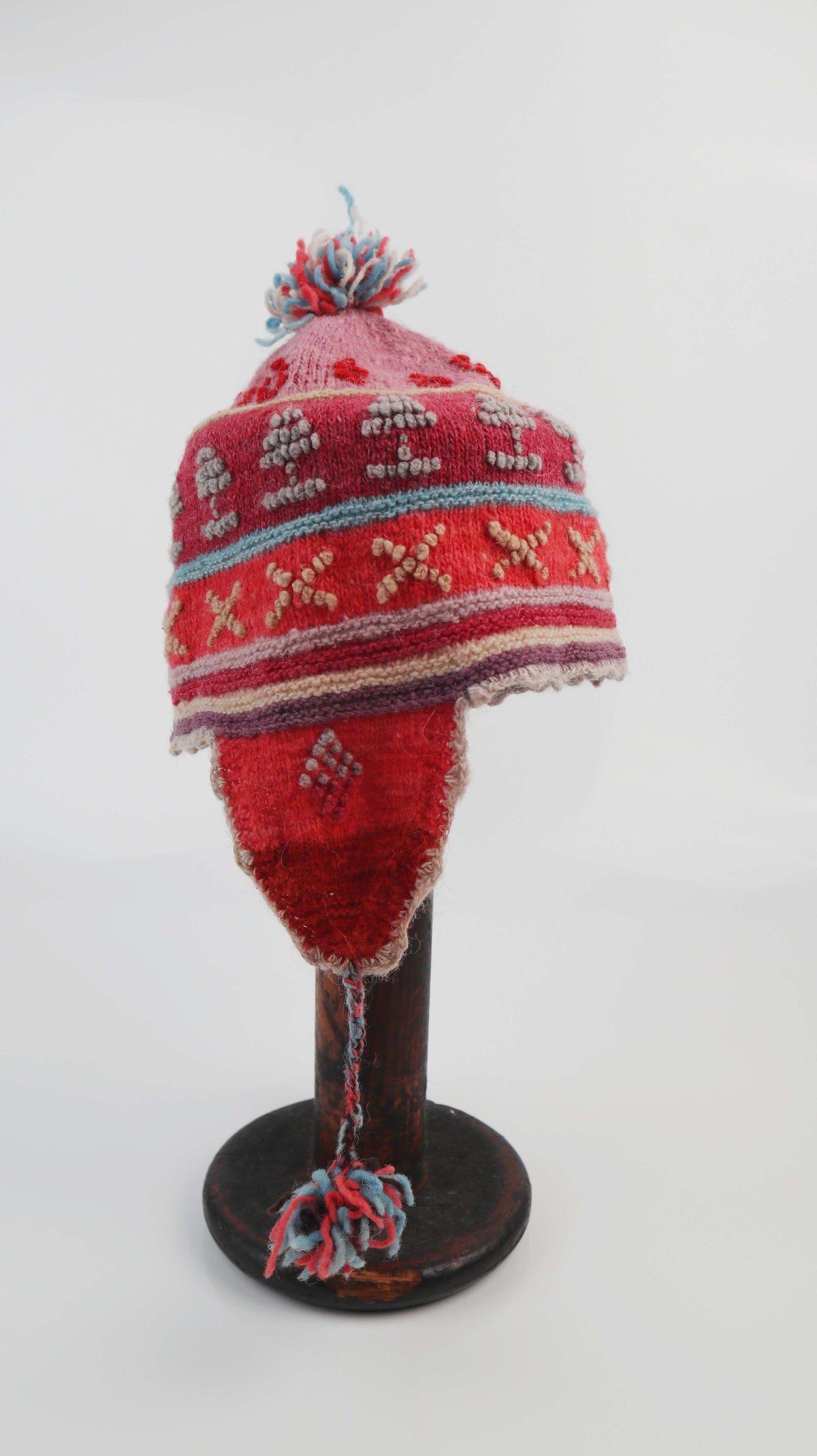 Peruanische Chullo Mütze Wollmütze rot rosa Kappe Bommel Ohrenklappen
